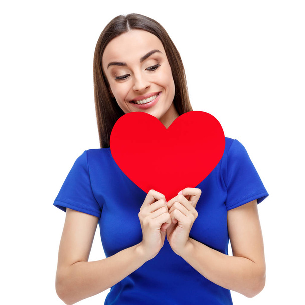 Beautiful woman holding heart shaped gift - Foto, afbeelding