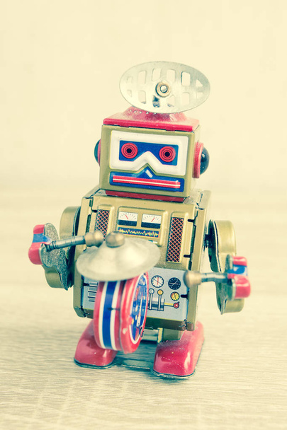 Старая игрушка робота на деревянном столе, винтажный стиль цвета
. - Фото, изображение