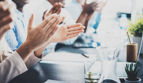 Closeup photo of partners clapping hands after business seminar. Professional education, work meeting, presentation or coaching concept.Horizontal,blurred background. - 写真・画像