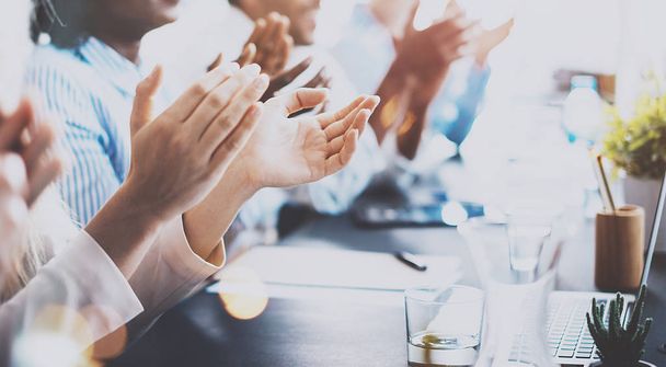 Close up of young business partners applauding to reporter after listening report at seminar. Professional education, work meeting, presentation or coaching concept.Horizontal,blurred background. - Foto, Imagen
