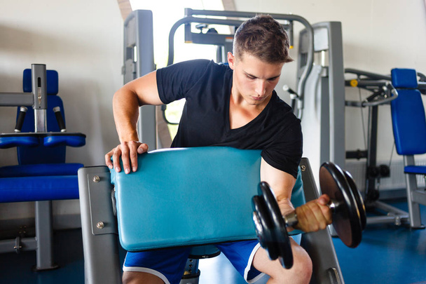 Biceps workout on smit bench. - Fotó, kép