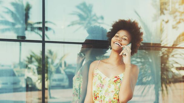 Portrait of laughing black brazilian girl speaking on the phone - Φωτογραφία, εικόνα