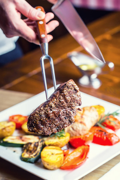 Beef Steak. Sirloin steak. Delicious juicy beef steak on fork. grill  vegetables - Фото, изображение