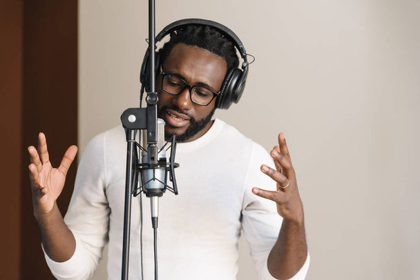 African young man singing on musical studio. - Fotografie, Obrázek