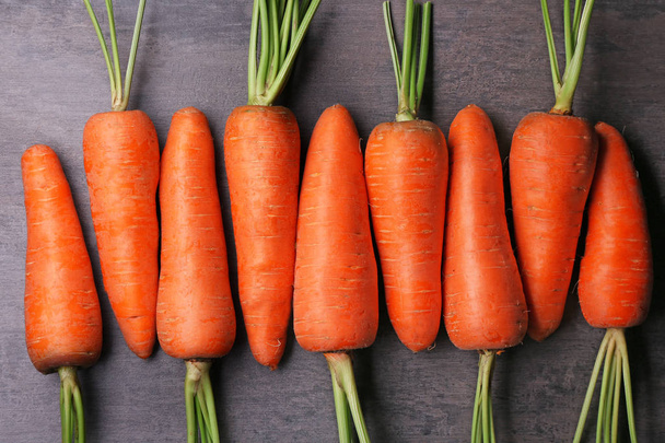 Fresh carrots on color background - 写真・画像