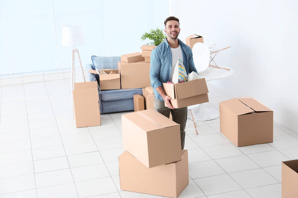 House moving concept. Man holding cardboard box, closeup - Foto, afbeelding