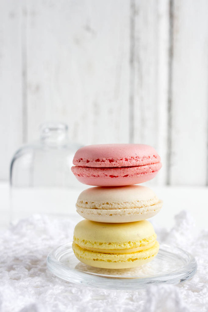 Colorful French macaroons on a white wooden background - 写真・画像