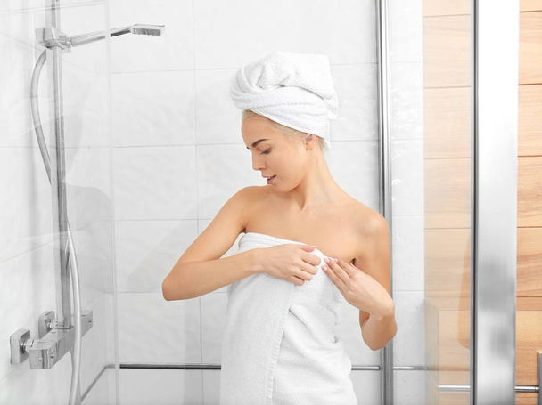 Beautiful young woman in towel going to shower - Фото, зображення