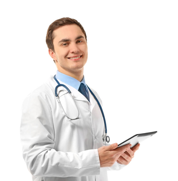Young male doctor with tablet on white background - Fotografie, Obrázek