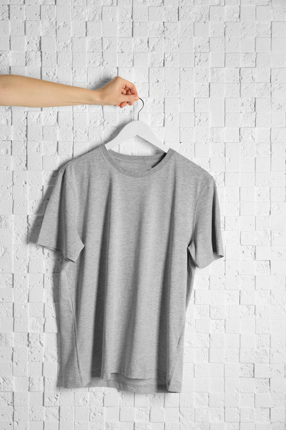 hand holding blank grey t-shirt  - Фото, зображення