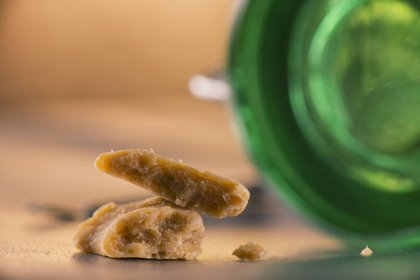 Marijuana extraction concentrate aka wax crumble with green glas - 写真・画像