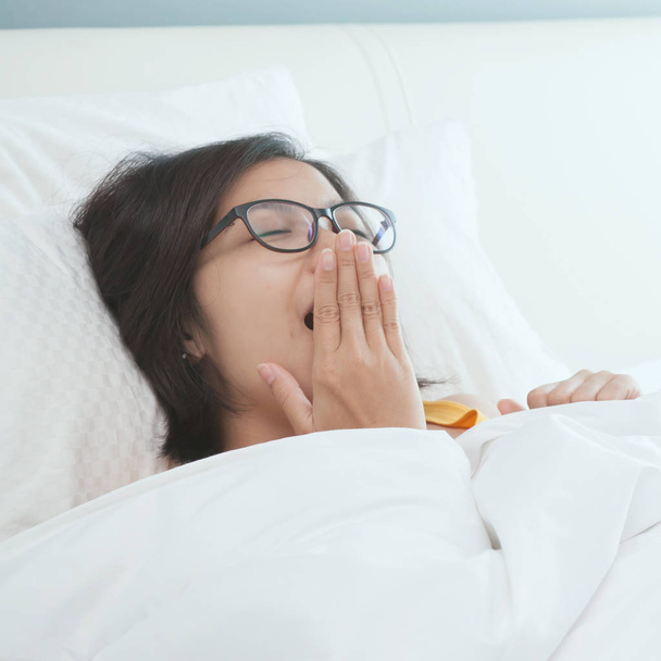 Beautiful young Asian woman waking up in the morning.  - Φωτογραφία, εικόνα