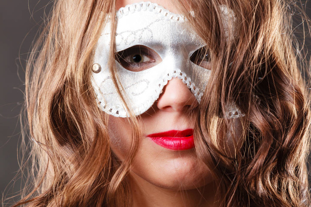 Woman with carnival venetian mask closeup - 写真・画像