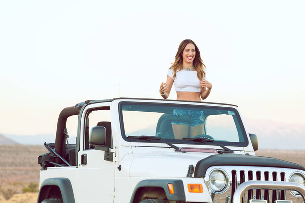 Beautiful Happy Smiling Young Lady Standing In Convertible Car. - Foto, Imagen