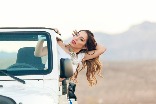 Seductive Young Woman In Convertible Car Hanging Out Window With Hair In Wind. - Foto, Bild