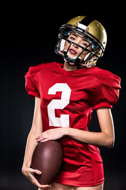 Female football player in helmet - Foto, Imagen