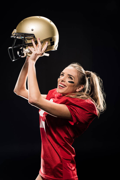 Female football player cheering with helmet - Foto, afbeelding