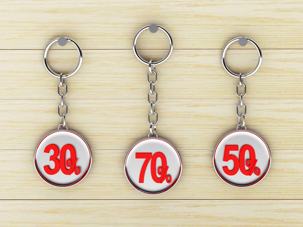 Set of metal keychains with different percentages discount is hanging on the wooden - Photo, Image