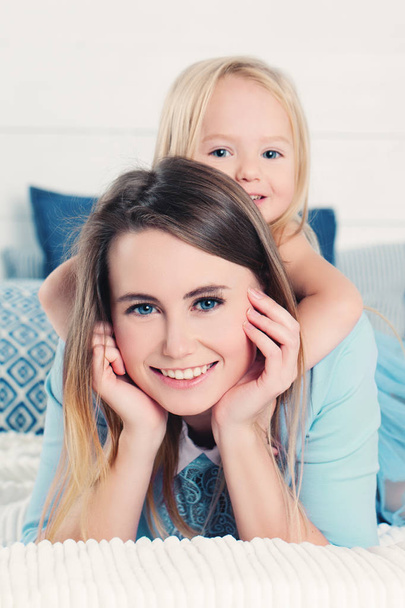 Cute Woman with Little Girl. Mother with Daughter - Фото, изображение
