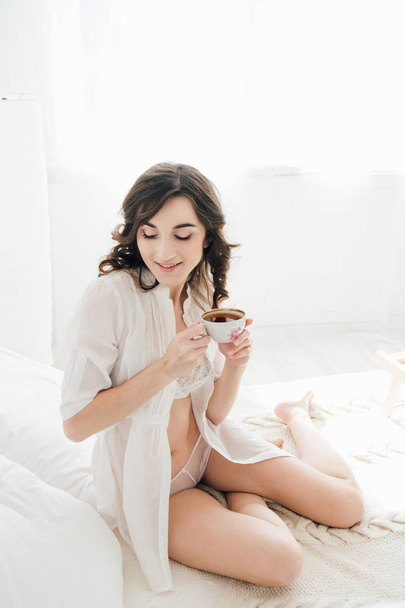 Girl drinking tea in bed in the morning - Zdjęcie, obraz