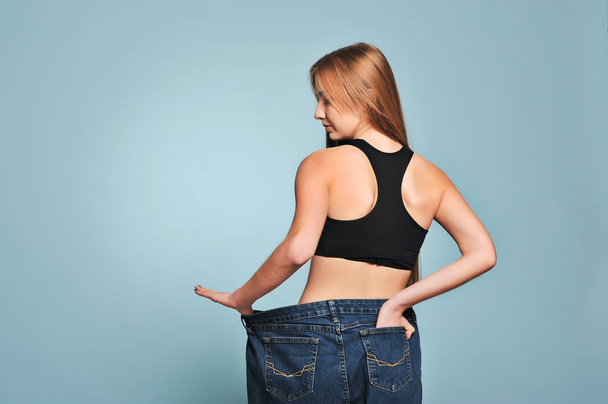 Women shows her weight loss. - Fotografie, Obrázek