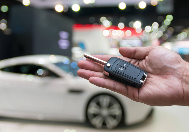  hand holding and giving a car key remote - Photo, Image