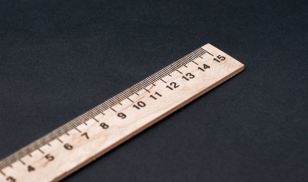 fifteen cm. Regular size. Wooden ruler on a black background. Ruler Simple. School board background. 1 5 - Photo, Image