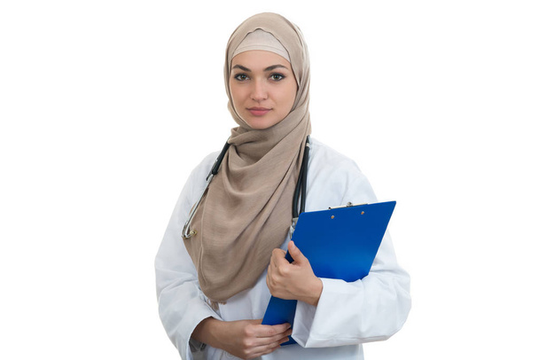Confident muslim female doctor holding folder. - Фото, изображение