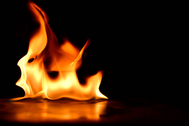 Beautiful fire flames on a black background. - Photo, Image
