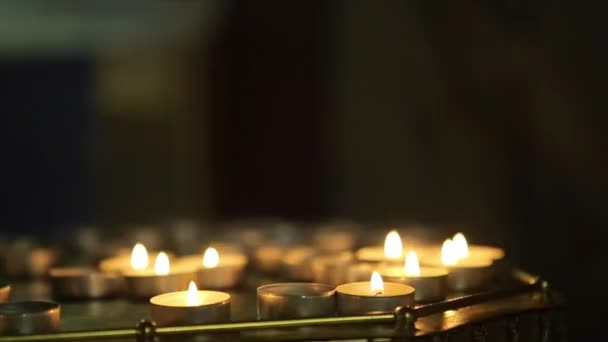 Sok gyertya ragyogott a sötét-templom a lángok - Felvétel, videó