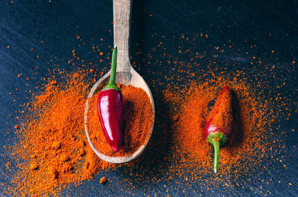 Red chilly peppers, spicy on a wooden spoon. Chilly on a wooden spoon. Vegetable. Concept of hot food.  - Foto, imagen