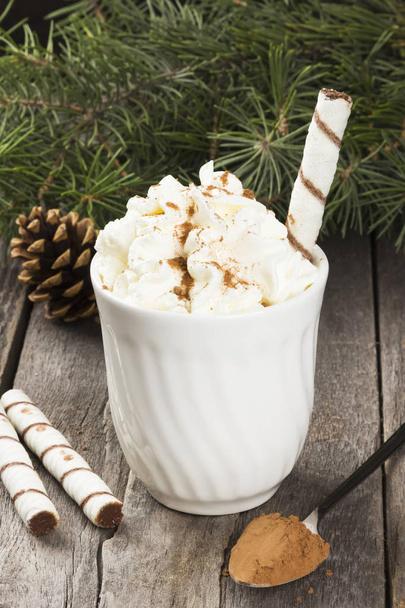 Cup of hot cocoa with cream on a dark background - Foto, Imagen