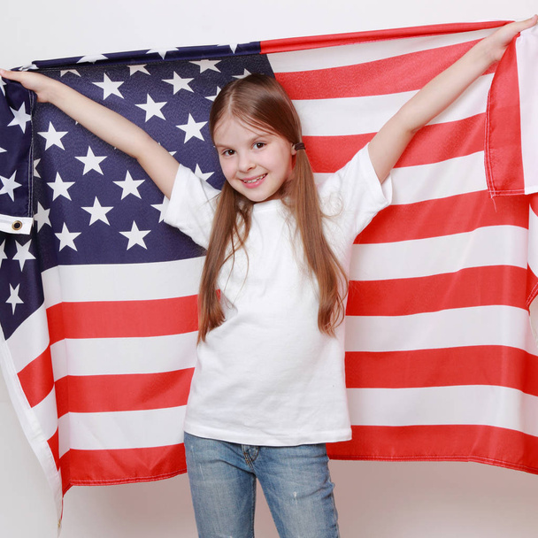 Little girl and American flag - 写真・画像