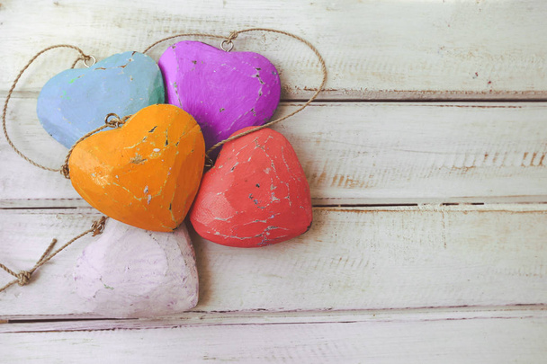 Selective focus on colourful heart shape on white wooden background  - Photo, Image