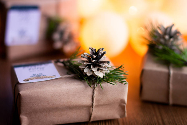 Decorated gift boxes and garland on the wooden background - Фото, зображення