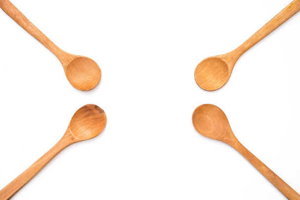 four empty wooden spoons on white background - Photo, Image