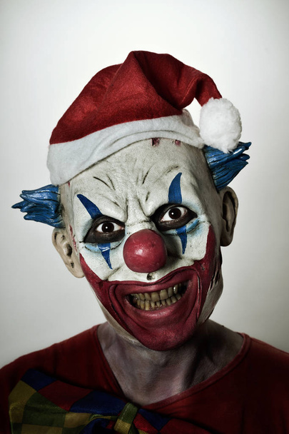 spaventoso male clown con un cappello di Babbo Natale
 - Foto, immagini