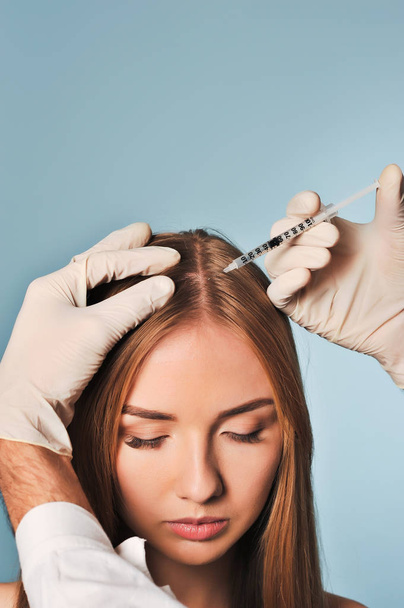 woman is getting injection in head. Mesotherapy. - Foto, Imagen
