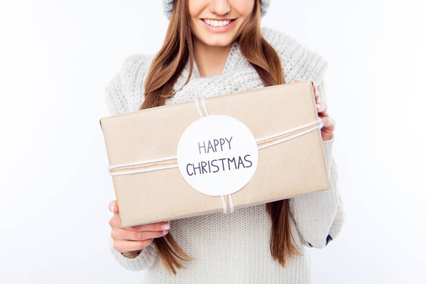Cheerful woman  in warm hat and scarf holding package and congra - Foto, imagen