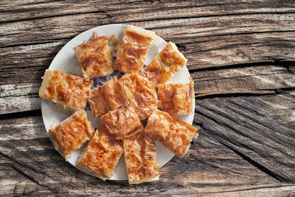 Plateful, Сербський традиційні м'ята сир пиріг скибочками набору на старих дерев'яних вузлом тріщинами пікніку таблиці  - Фото, зображення