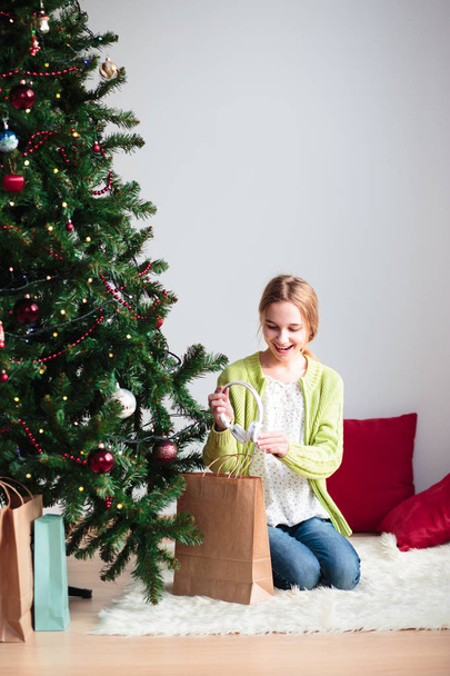 Girl pleasantly surprised at Christmas gift - 写真・画像