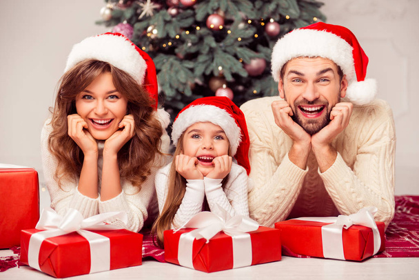 Portrait of cheerful happy family of three people with xmas gift - Foto, Bild