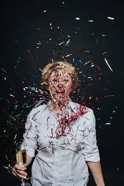Cheerful female with champagne in confetti - Photo, image