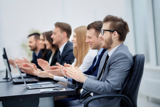 Photo of happy business people applauding at conference - Фото, изображение