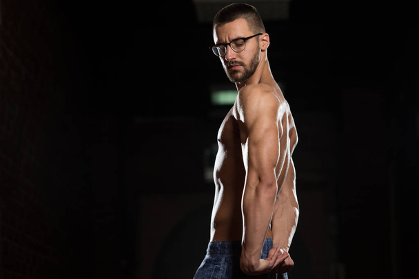 Muscular Geek Man Flexing Muscles In Gym - Foto, Imagen
