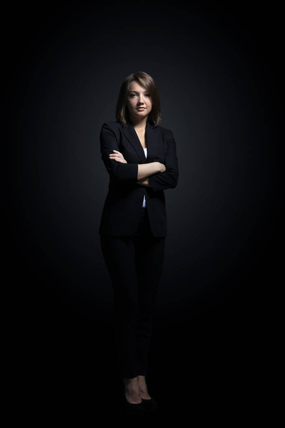 Full-length portrait of businesswoman  isolated on black backgro - 写真・画像