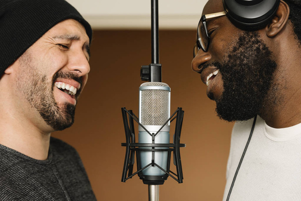 Multiracial artists singing on studio. - Zdjęcie, obraz