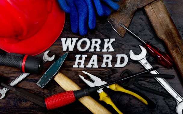 Tools and work hard written with letters on the wooden table which represent the popular phrase as lifestyle concept.  - 写真・画像