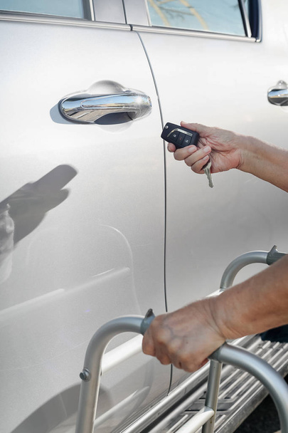Elderly woman hand open the car on key car alarm systems - Photo, Image