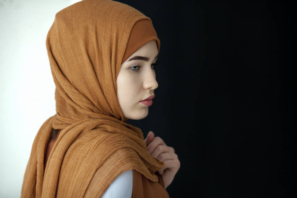 Portrait of a beautiful Muslim woman in a green scarf covering her head - Fotografie, Obrázek